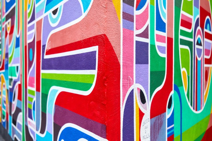 Vibrant abstract mural with colorful geometric shapes on a wall.