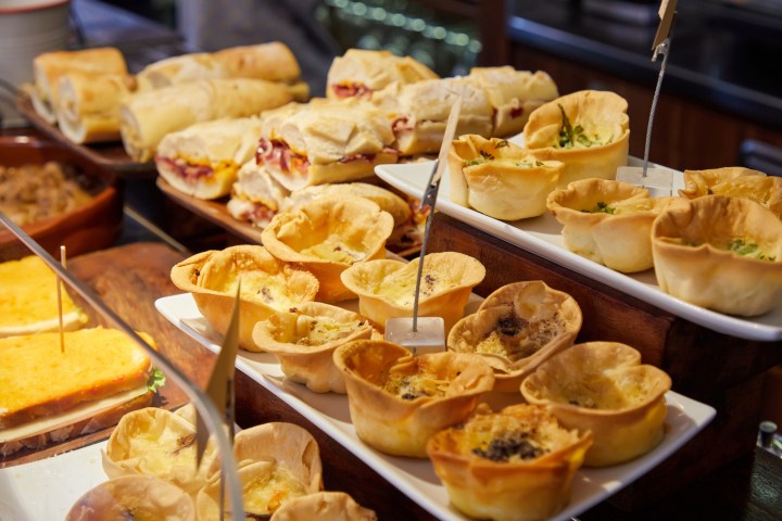 Assorted pastries and sandwiches on display at a bakery or deli.