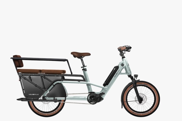 Electric cargo bike with rear bench seating and black frame.