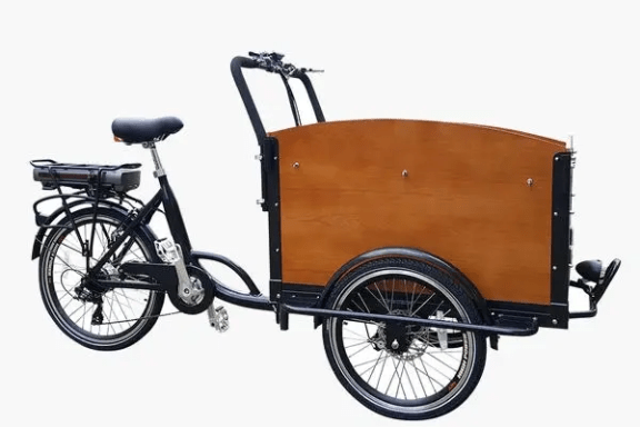 Electric cargo bike with wooden box on frame, three wheels.